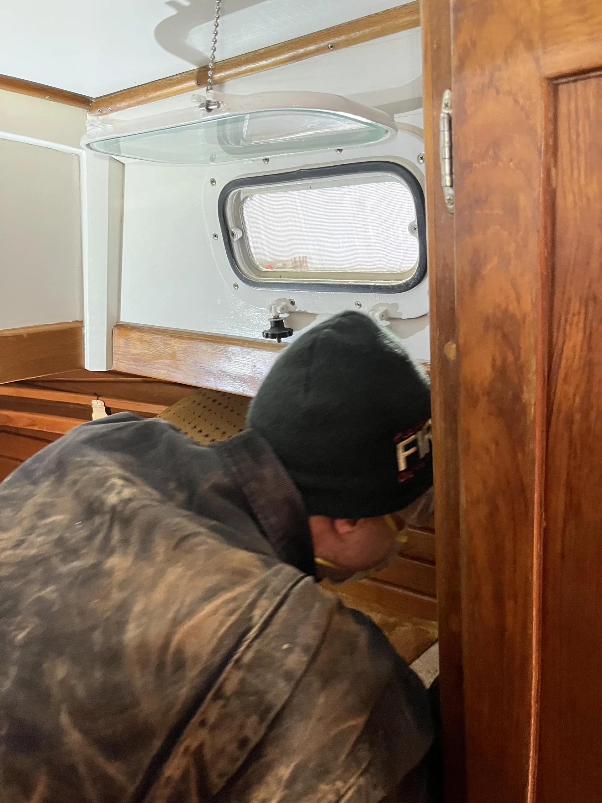 person removing boat cabin ceiling