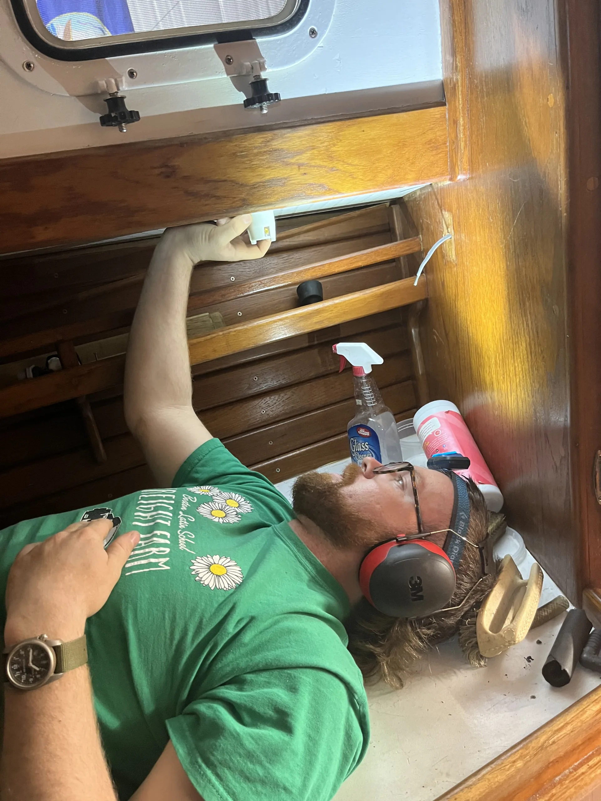 person installing power outlet on boat
