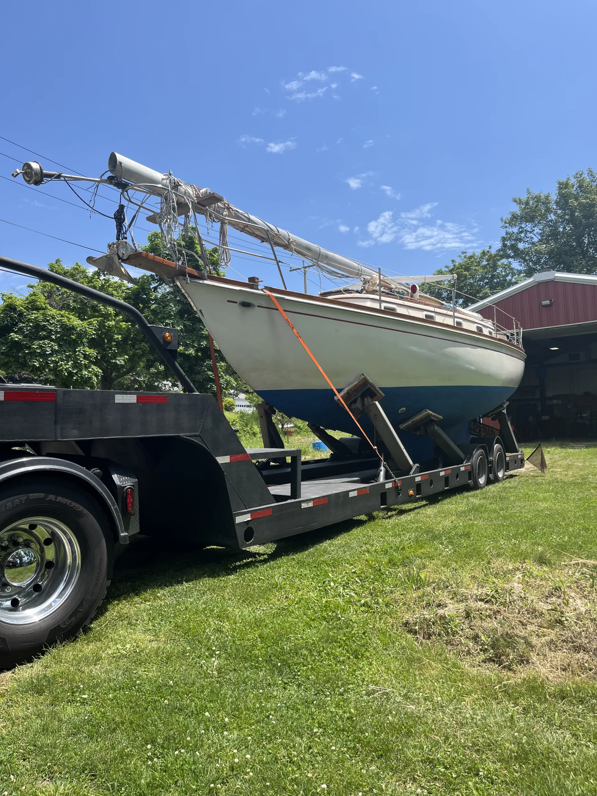 sailboat on truck bed leaving the barn